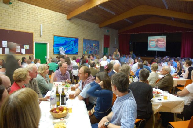 Dinner wit horse races projected on screen. | Michael Blakstad
