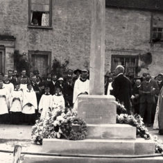 This shows the dedication of the new War Memorial commissioned by Rev. Thomas Heywood Masters and designed by Ninian Comper. y 11923, Masters was no longer vicar of East Meon and it is not known whether the clergyman to the left of the memorial is Masters or his successor Rev Crawley.