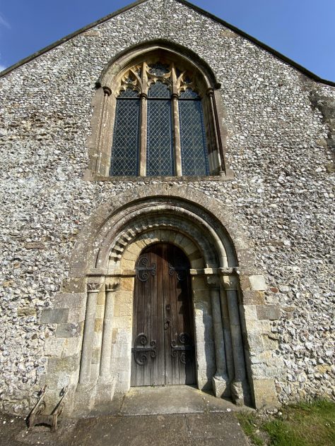 Romanesque arches and zig-zag beading on West Door.