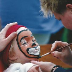 Girl having face painted
