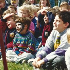 Kids watching arena event one with painted face